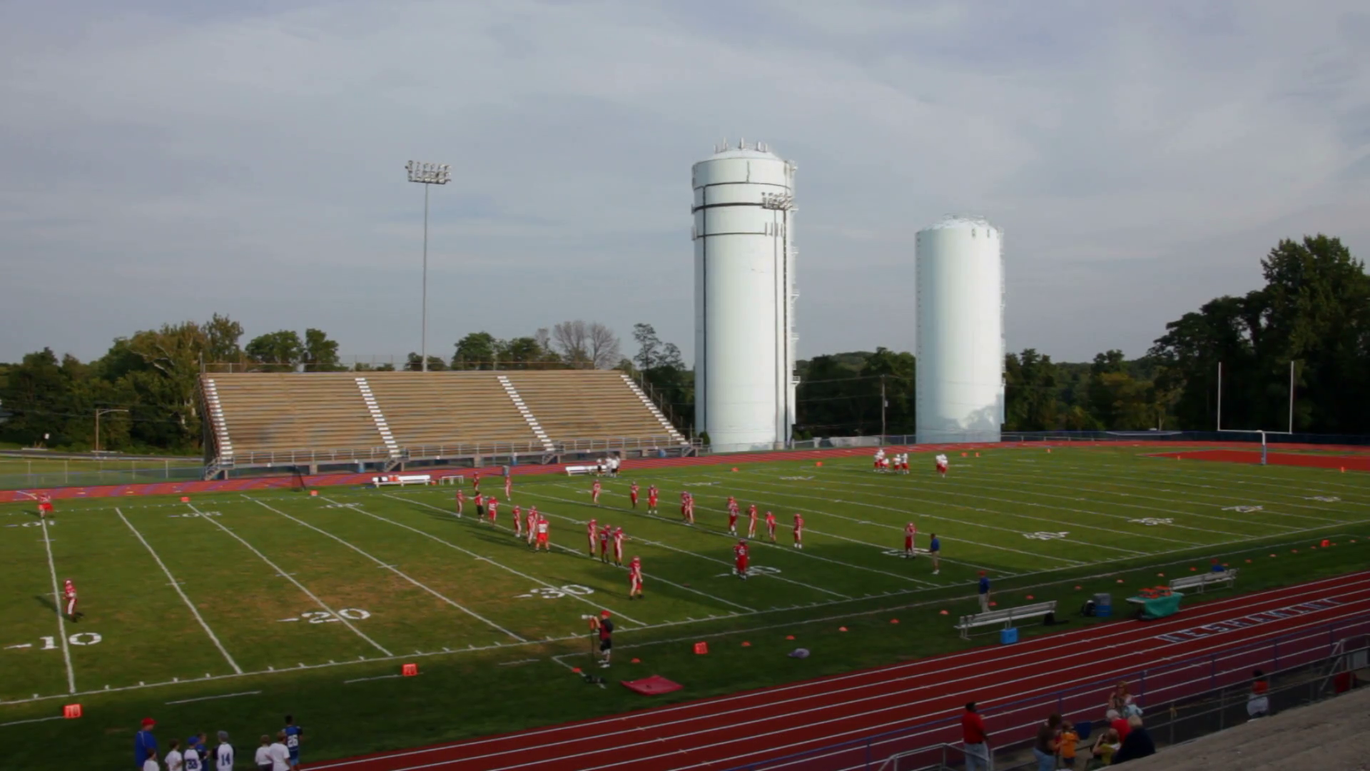 View from the bleachers of a high school football team warming up