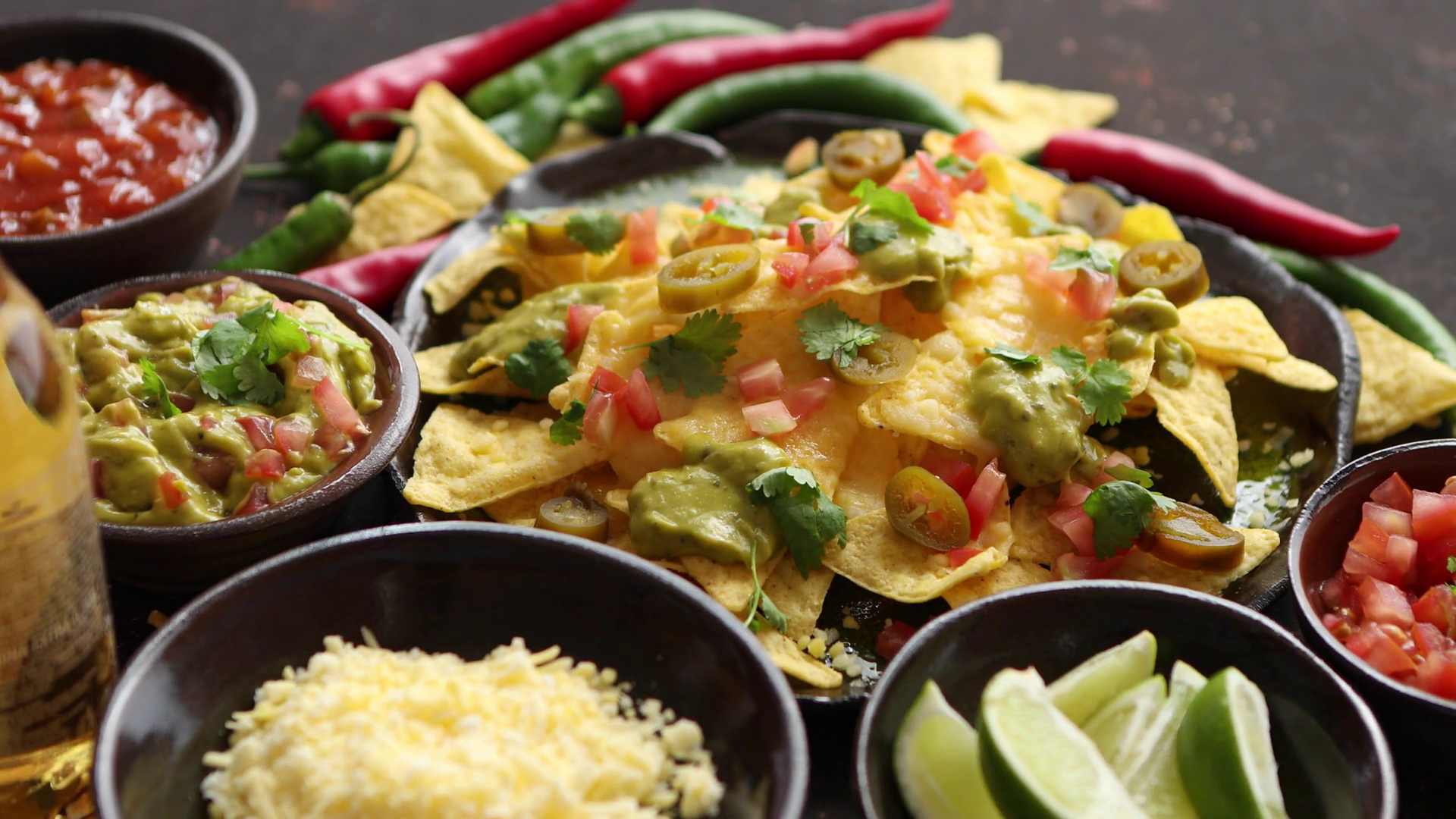 Fresh yellow corn nacho chips garnished with melted cheese, peppers and