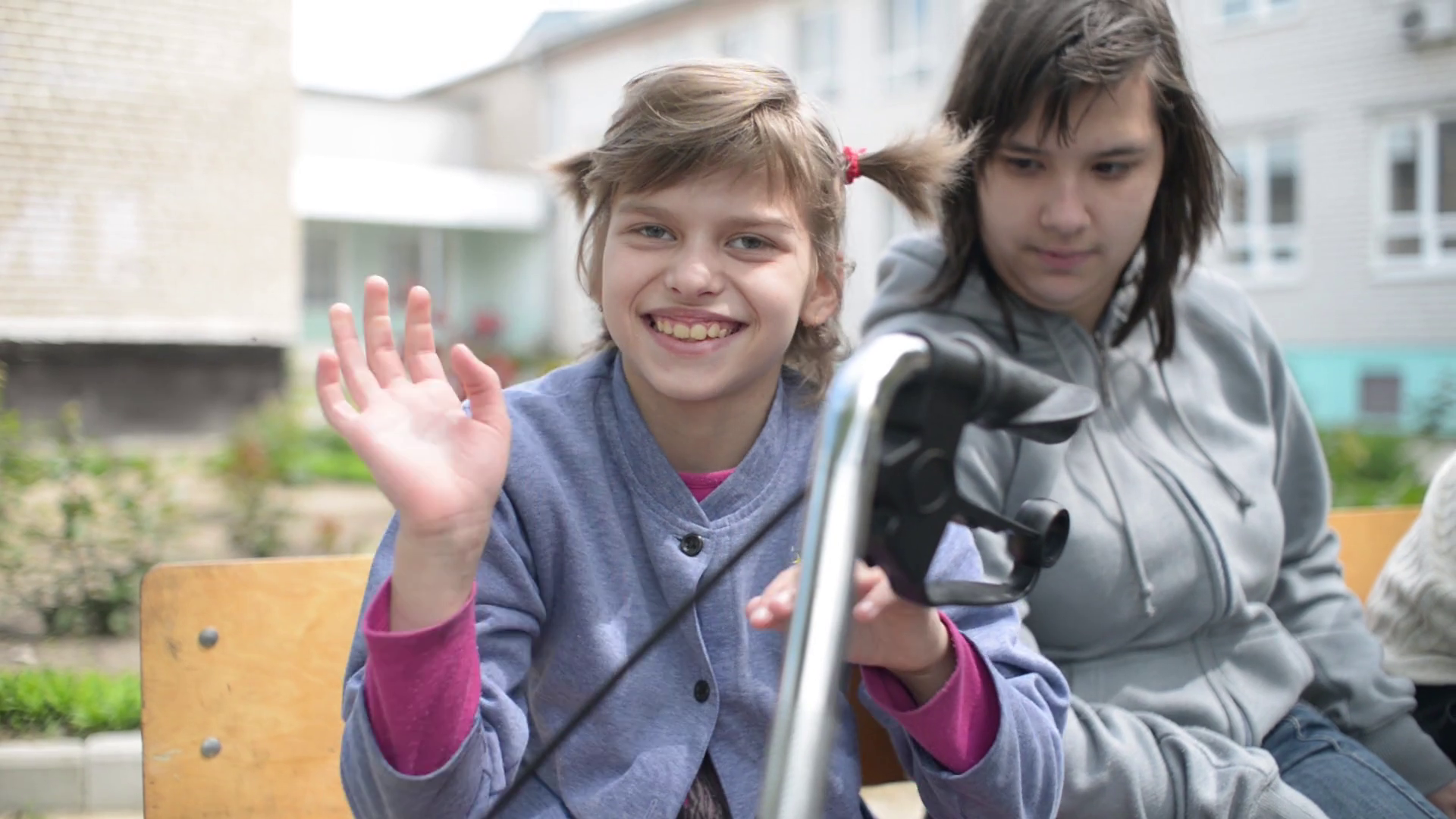 Children with physical development disorders on wheelchairs smiling to