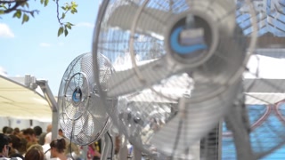 Fans humidified air blown crowd of people