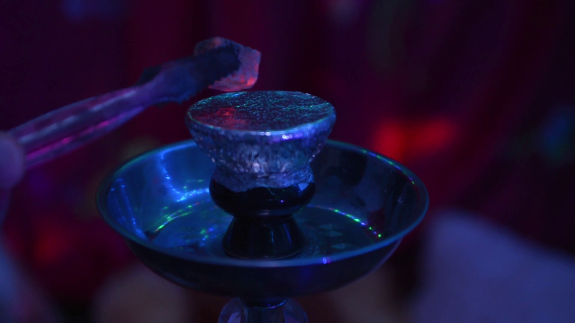 hookah smoking the guy lays out hot charcoal on the foil Stock Video Footage Storyblocks