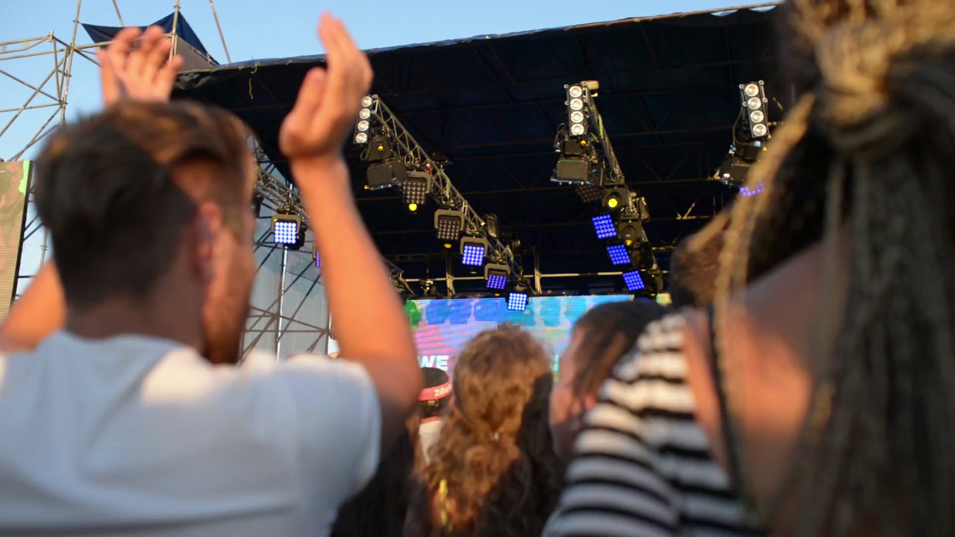People clap and wave their hands at a rock concert Stock Video Footage