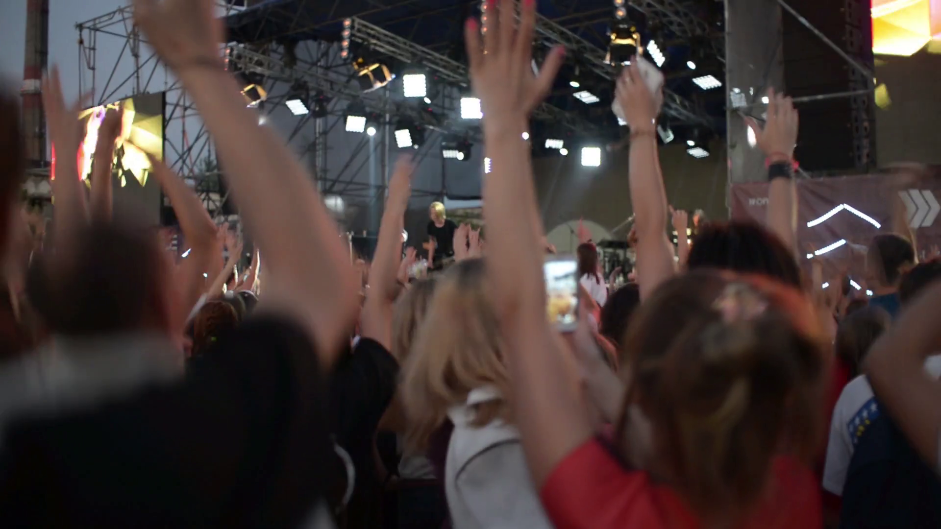 People clap and wave their hands at a rock concert Stock Video Footage