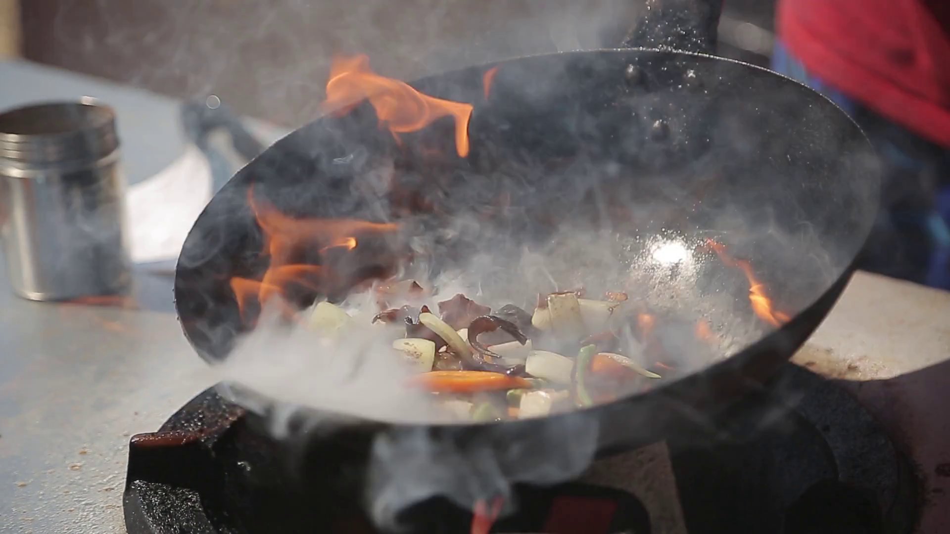 Chef Cooking With Fire In Frying Pan on a Street food Festival Stock