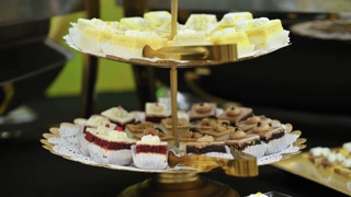 Close up shot of Candy bar, stands. Delicious desserts at the banquet, sponge cakes, shortbread tarts. move camera footage.
