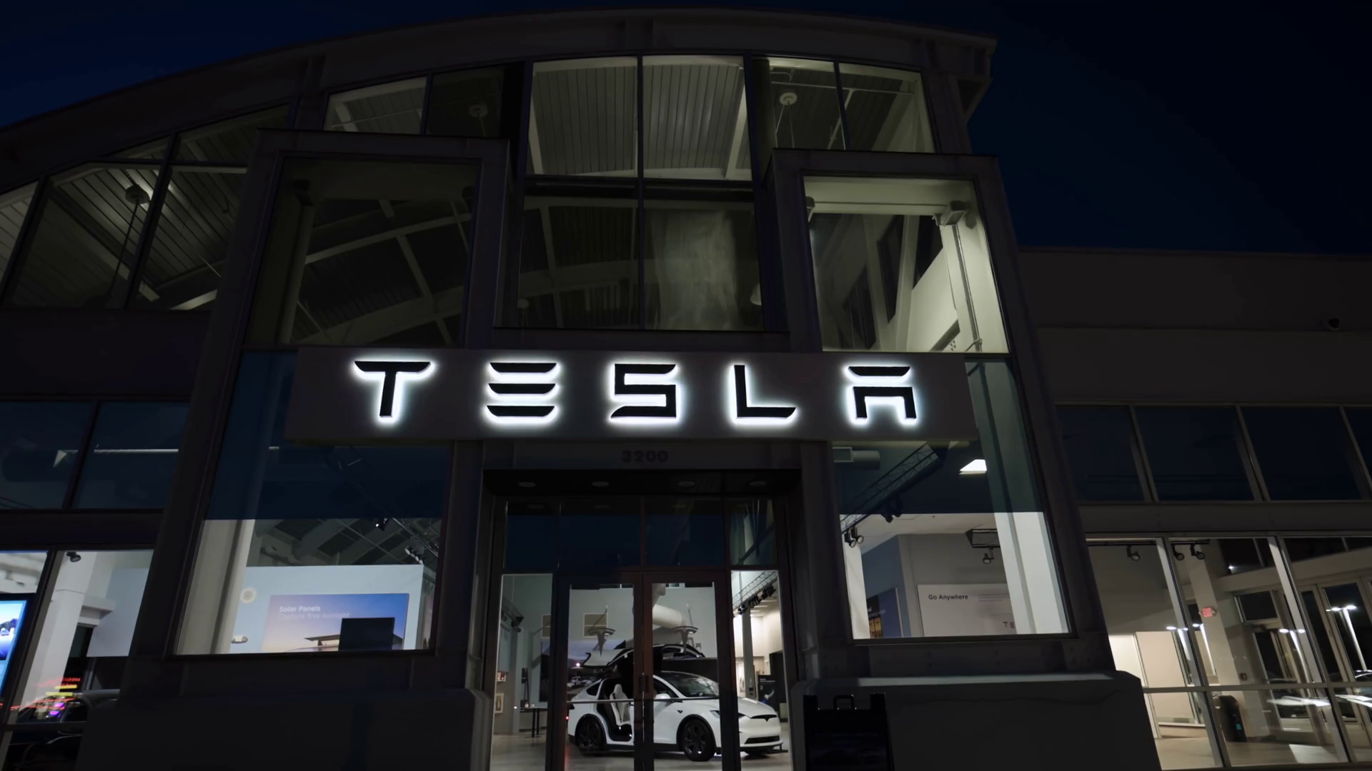 Exterior Sign Of Tesla Dealership With Sunny Stock Footage SBV ...