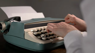 Close-up of vintage typewriter and hands typing. Retro writing process with mechanical keys and nostalgic atmosphere.