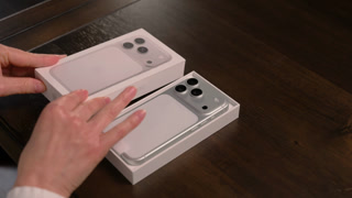 Hands unboxing a new smartphone iPhone 17. Clean modern tech lifestyle scene. US IL Chicago 8 Jan 2026