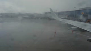 View from the porthole of the plane on a rainy day. Close up shot footage