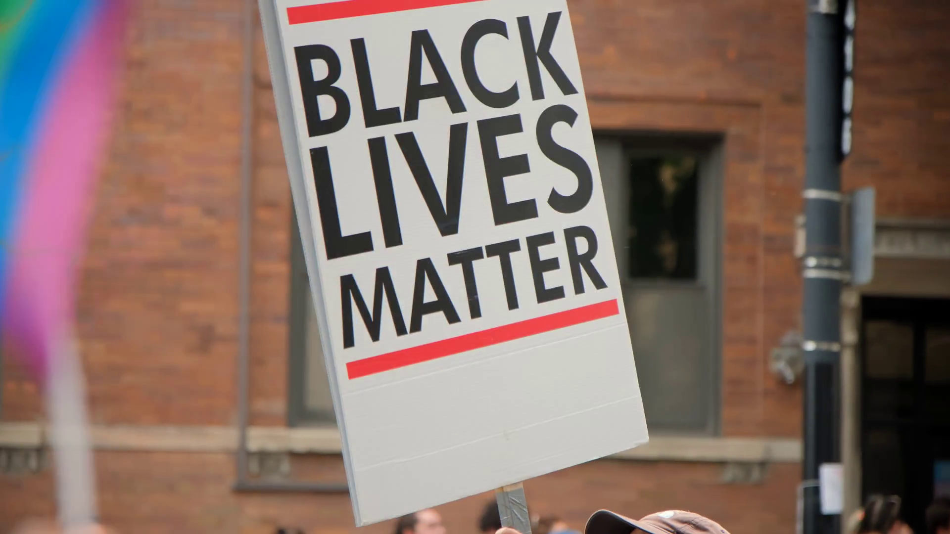 a-hand-holding-up-poster-with-slogan-black-stock-footage-sbv-348462184