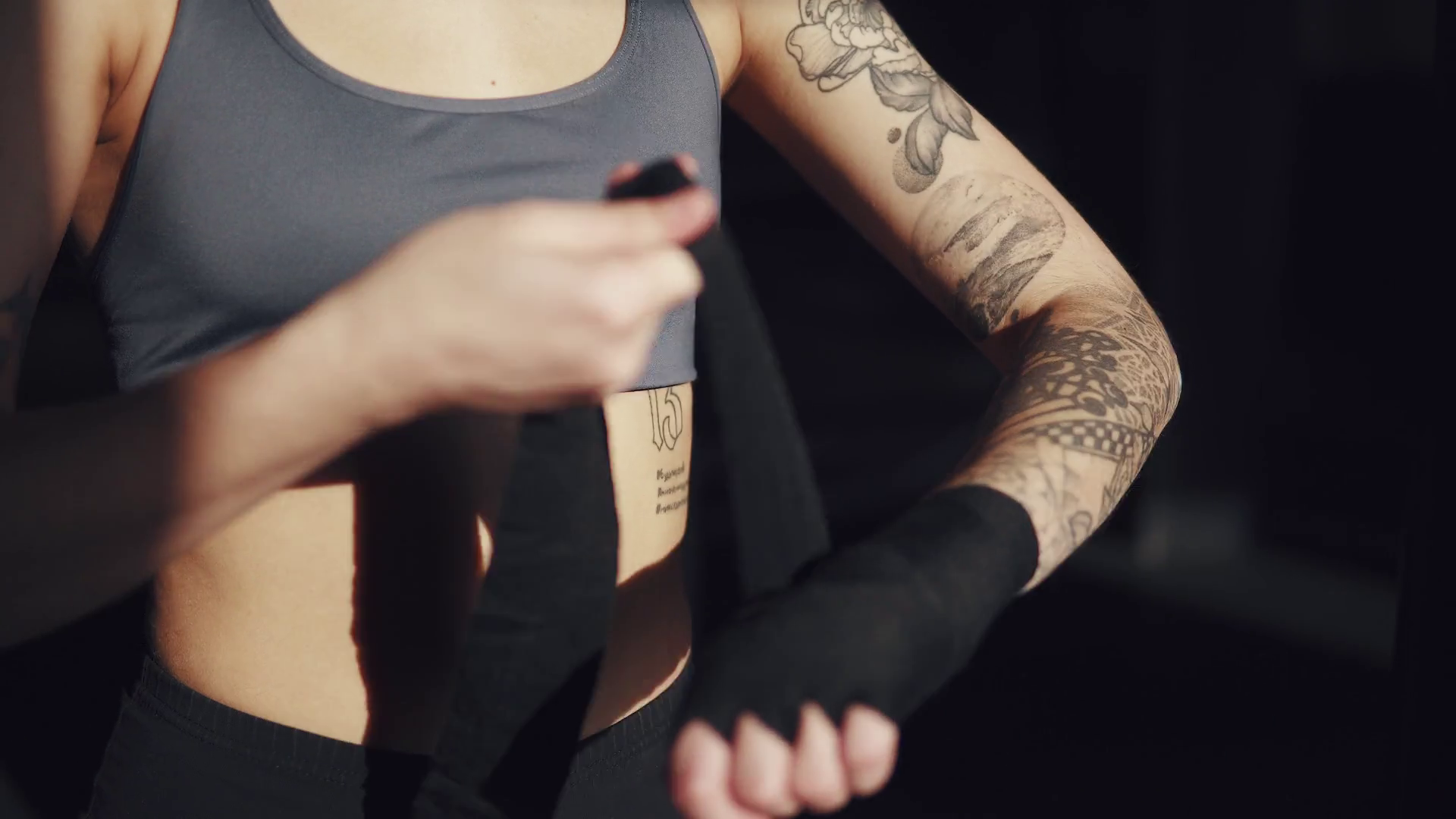 athlete pulls on his wrists protective bandages before boxing training