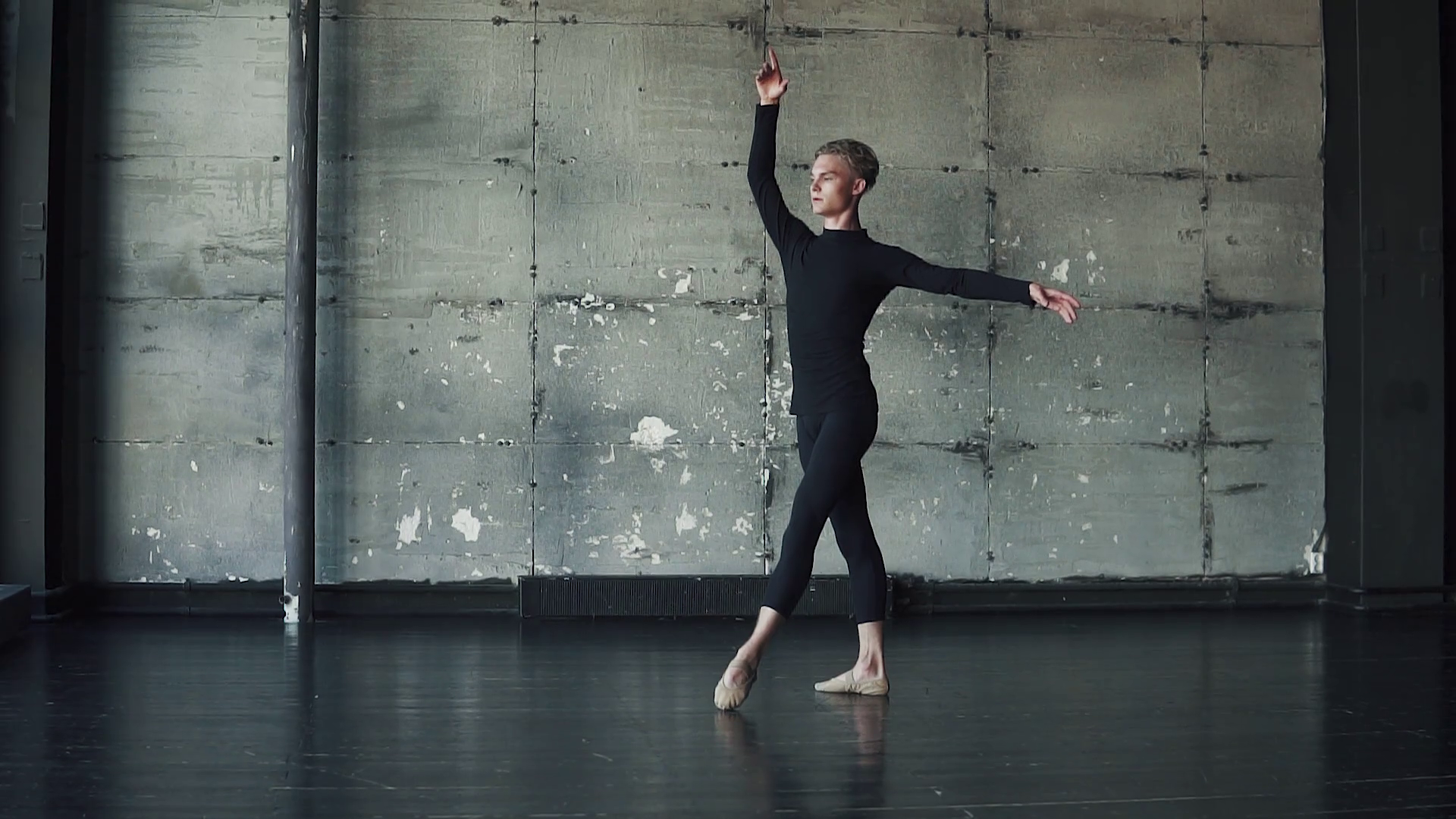 portrait of a male ballet dancer dancing classical ballet in the studio on a dark background