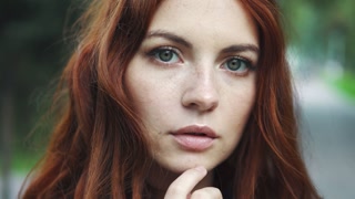Closeup Portrait of a Stunning Red-haired Woman Outdoors