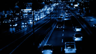 Night traffic time-lapse on highway with blue tint Cars moving fast