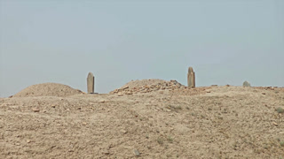 8K Turkmenistan desert cemetery with gravestones and obelisk markers on barren burial ground. Arid necropolis featuring memorial stelae across remote sepulchral landscape beneath clear sky.