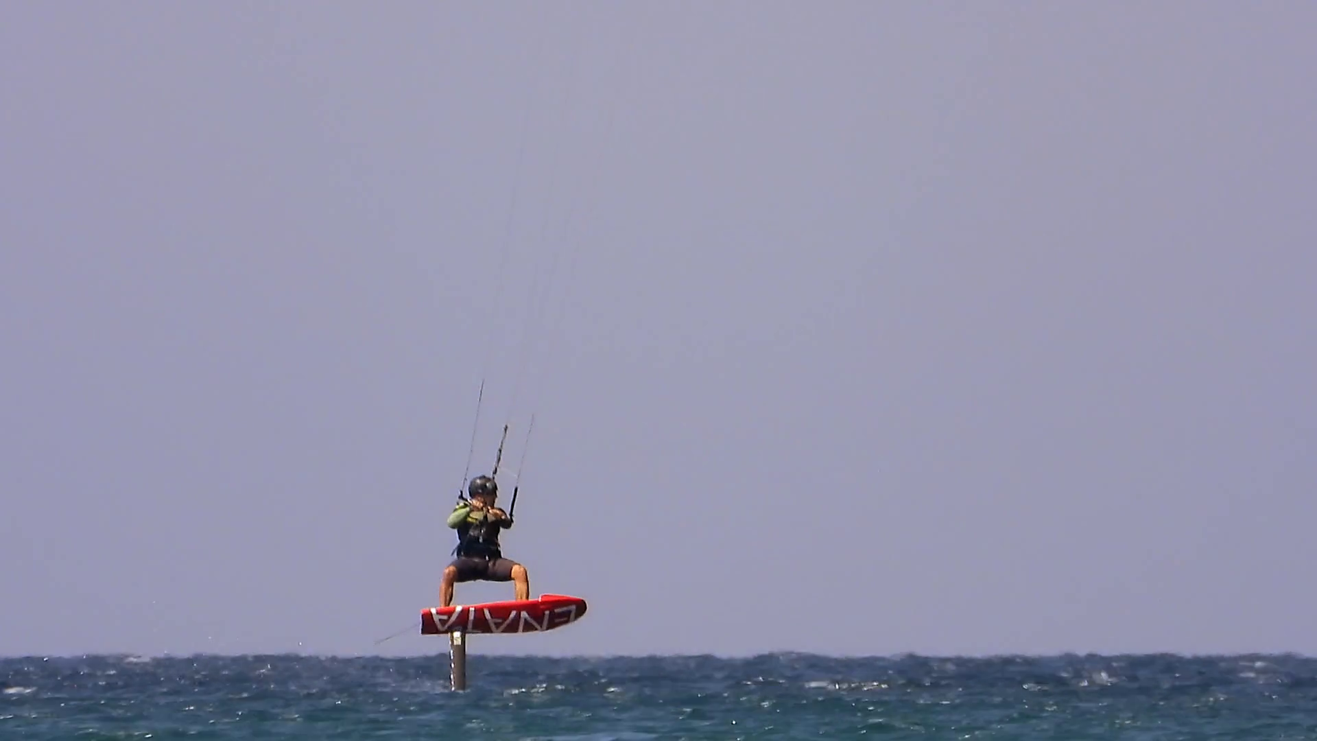 Kiteboarding, Kitesurfing Kiter and Kiteboarder is Pulled Across Sea Water by a Wind Power Kite