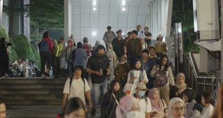 Commuters exiting the metro station during evening rush hour, slow motion