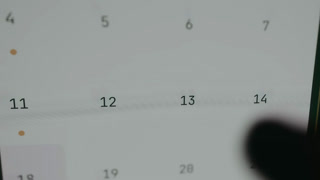 Interactive calendar screen with a finger choosing the 13th date
