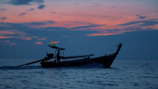 Traditional Thai Longtail Boat Cruising at Sunset in Mueang Krabi Thailand Slow.