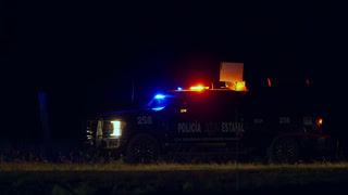 Mexican State Police Truck with Flashing Emergency Lights Parked at Night Scene