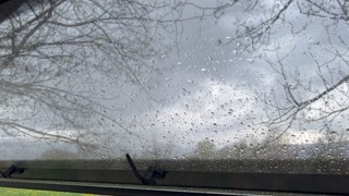View from inside a caravan with an open window during a rainy and thunderous day in La Cerdanya, Spain.