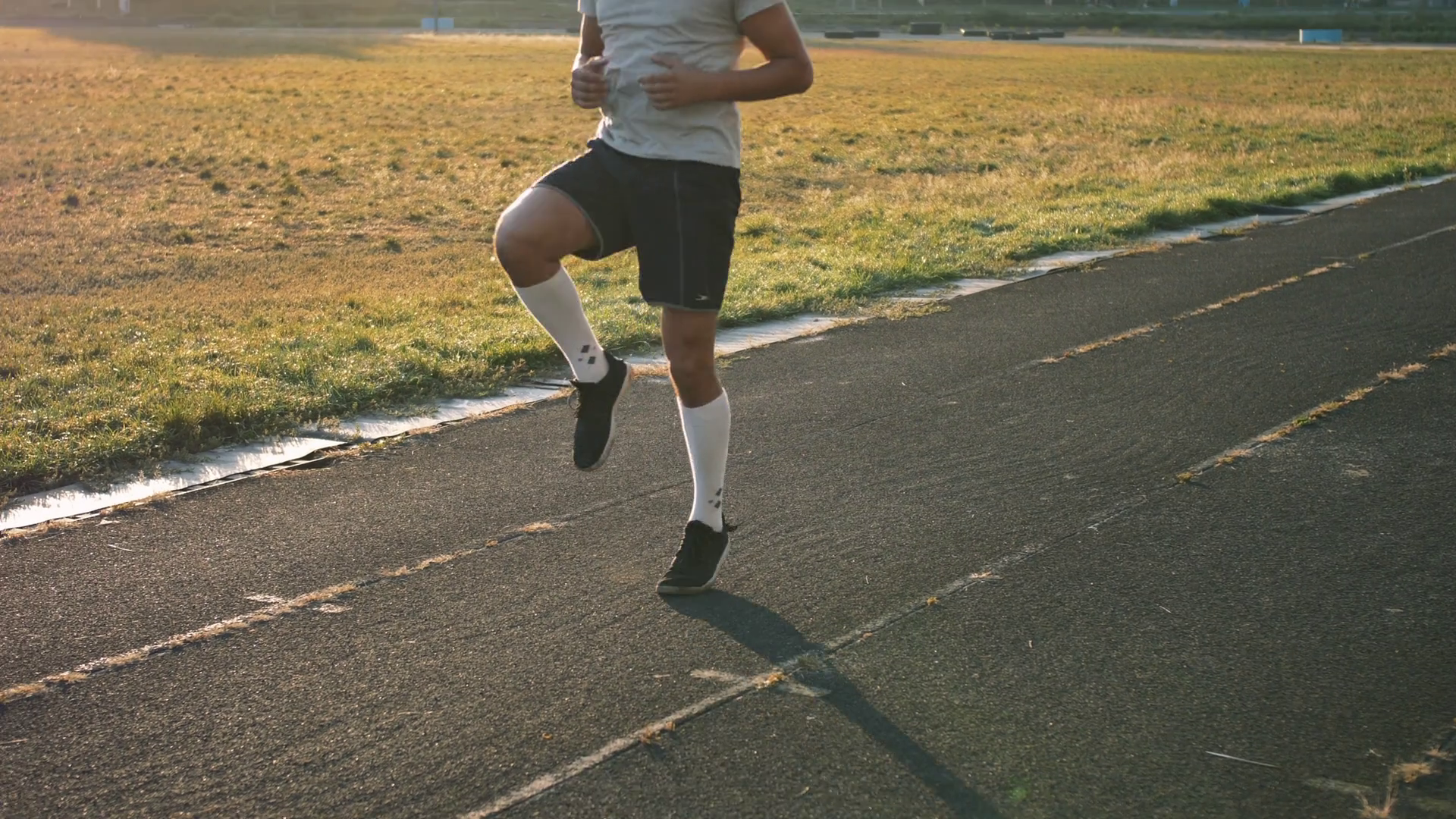 Mixed race athlete runner does high knees, while running in place at