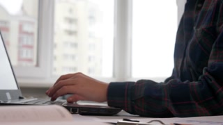 Finance Manager Working on Laptop with Business Documents and Technology