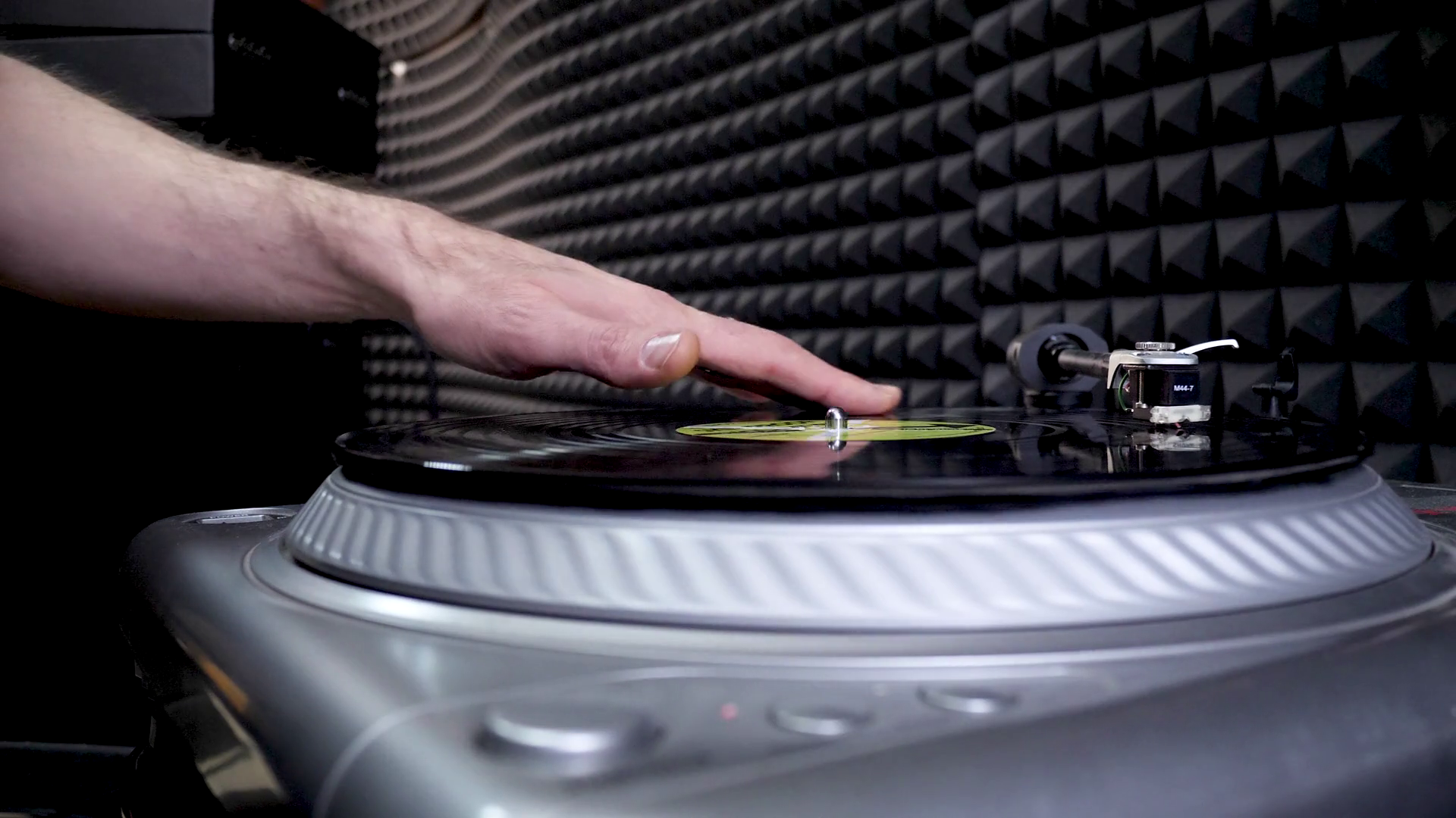 DJ Mixing and Scratching vinyl disc in professional record studio