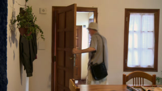 Blurred Elderly Man in Hat with Shoulder Bag Leaving Home through Wooden Door - 4K