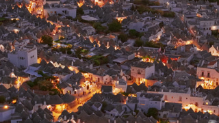 Aerial night view of the illuminated Trulli in Alberobello, Puglia, Italy