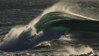 Tight barrel breaks with glowing sunlight, glassy water surface and smooth slow form