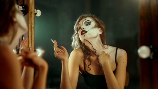 Madness and split personality, woman playing role, admiring her makeup, smoking. lady looking at her reflection in mirror, professional