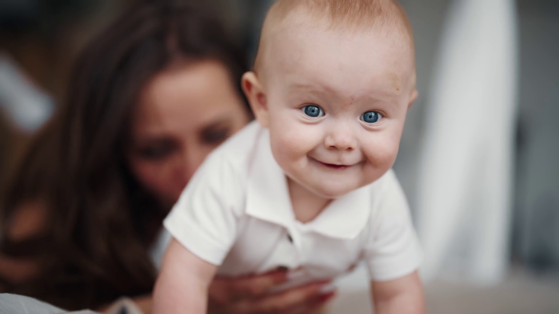 Mom Kissing Back Of Smiling Happy Baby Stock Footage SBV347559061