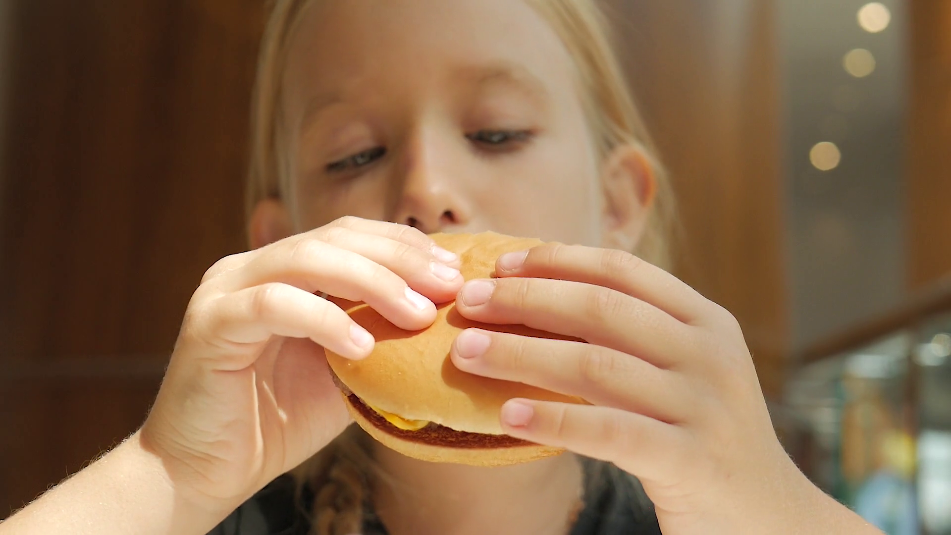 Adorable Baby Girl Enjoying Delicious Burger Stock Footage SBV