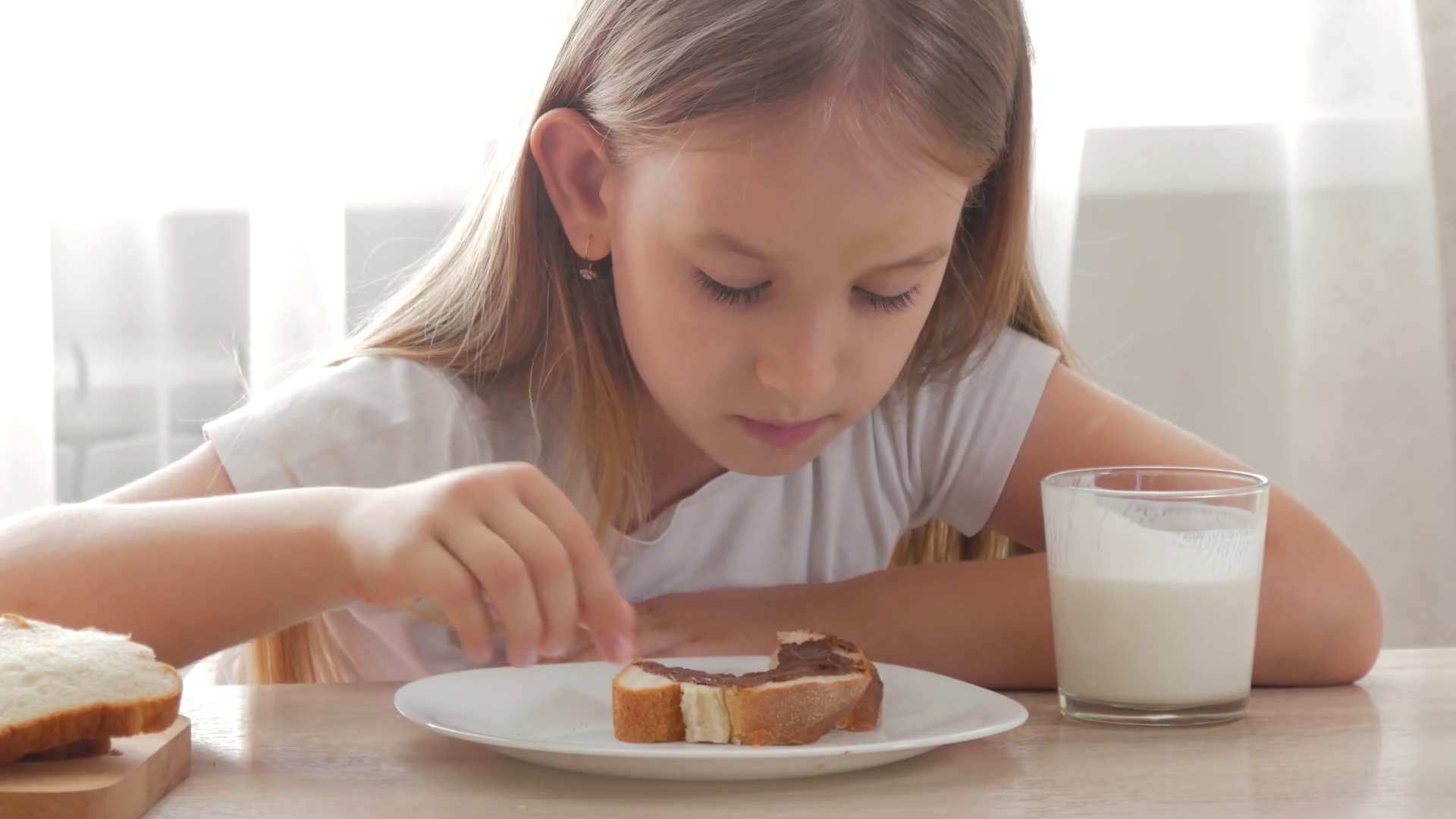 Child Drinking Milk Eating Sandwich Girl Stock Footage SBV323907143
