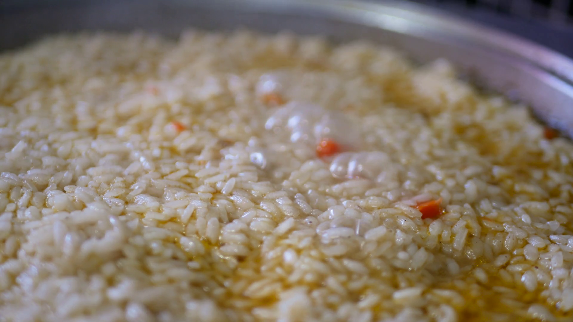 Cooking rice in metal pan on hotplate in kitchen Stock Video Footage 00