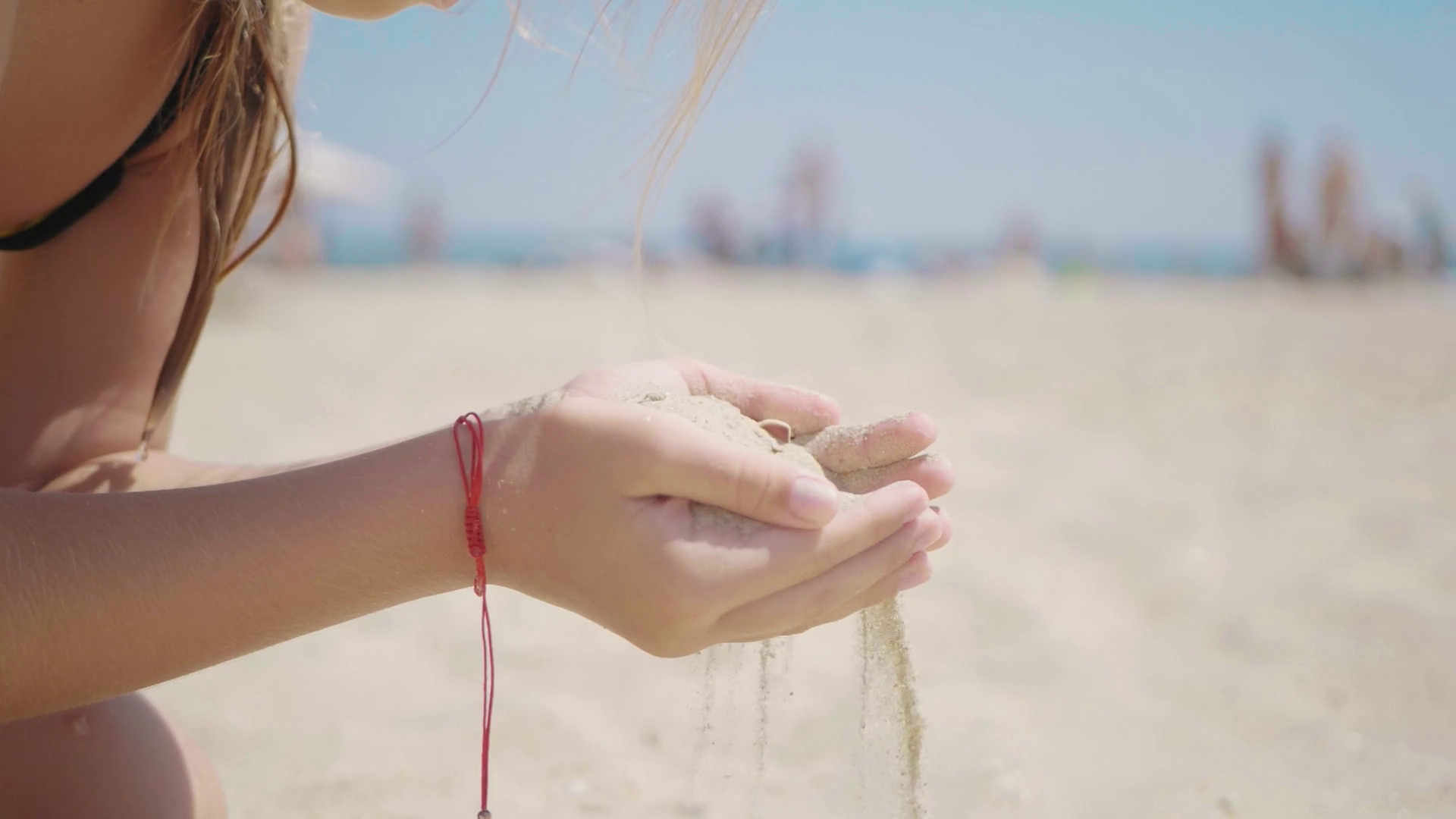 Sand as the time slips through your fingers. Little girl holding a sand