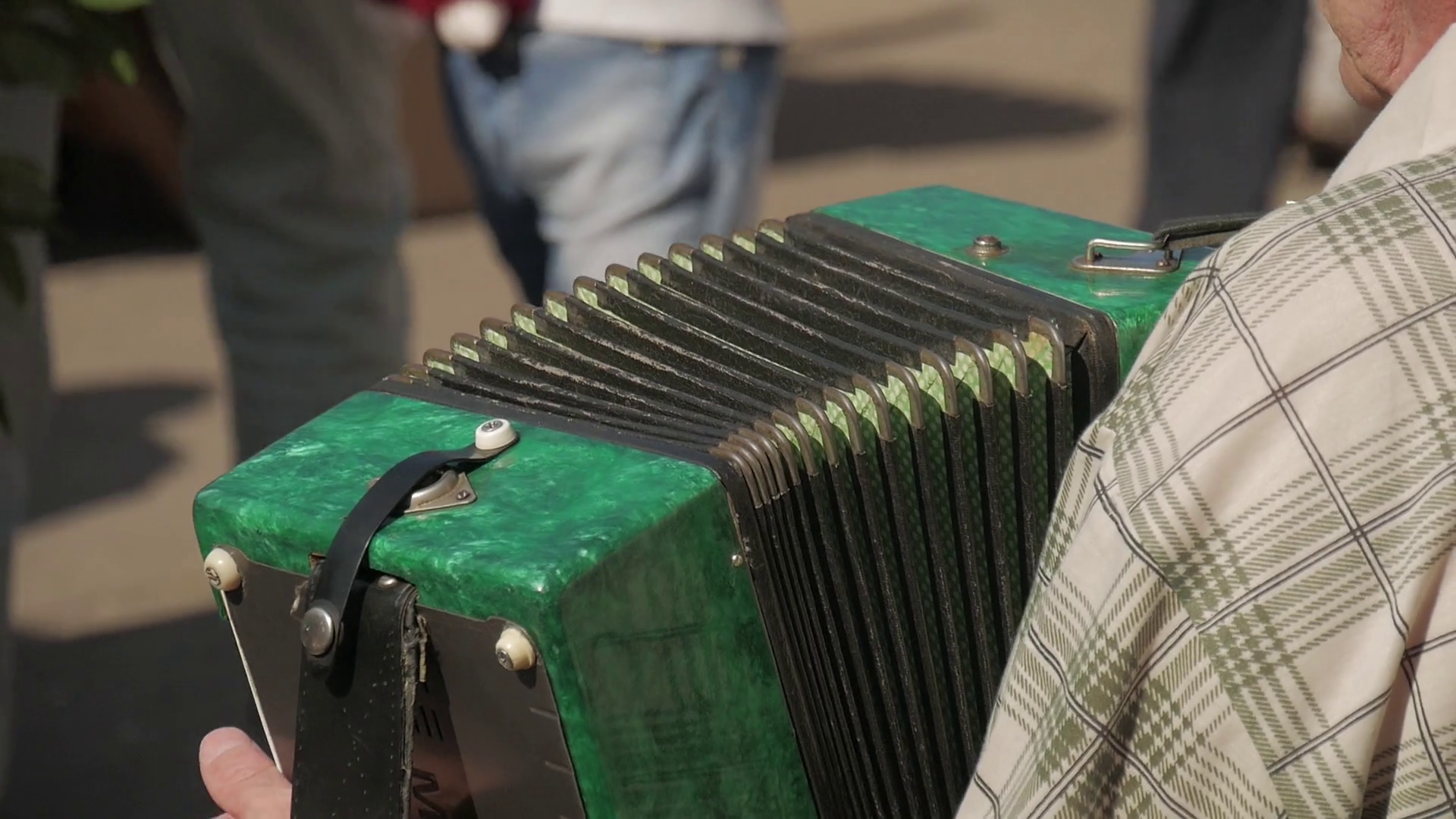 Street musician playing the accordion. Hand playing accordions closeup