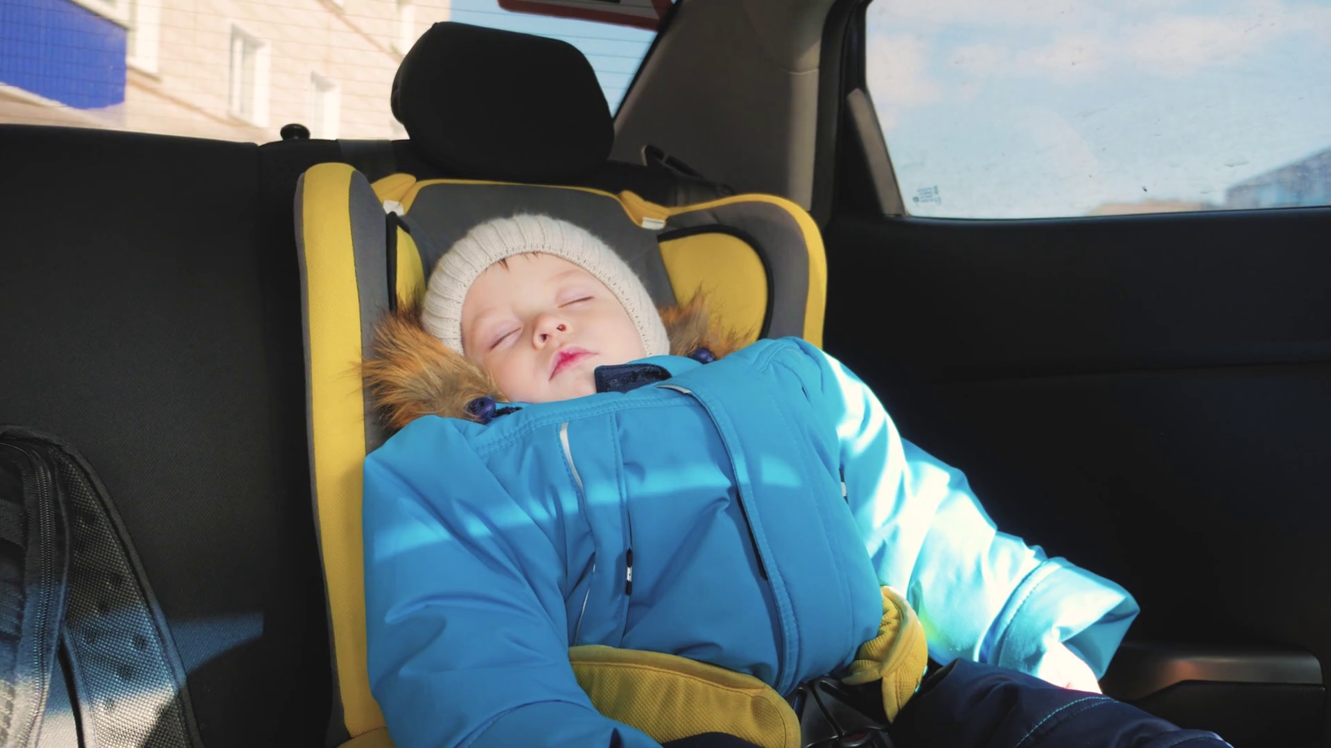Toddler boy sleeping in child safety seat in car. Stock Video Footage