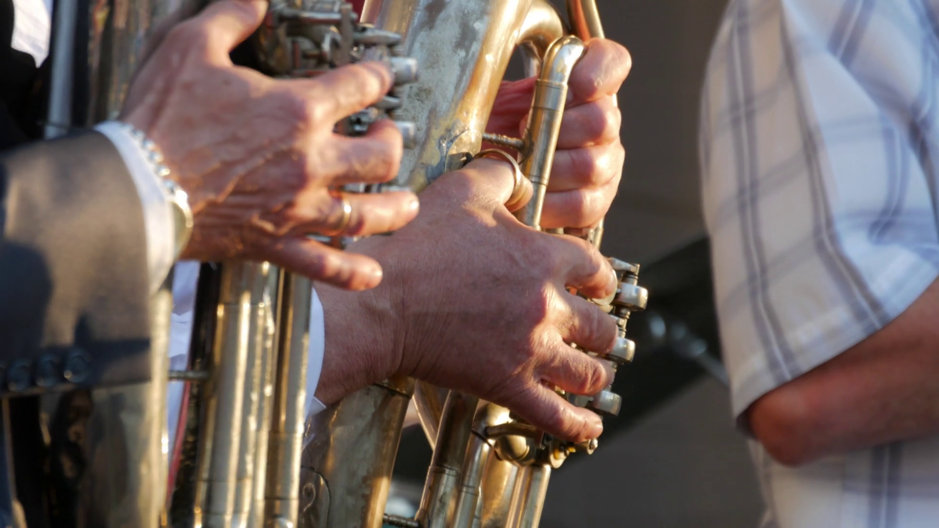 Trumpets in the hands of the musicians in the orchestra. Hands of the