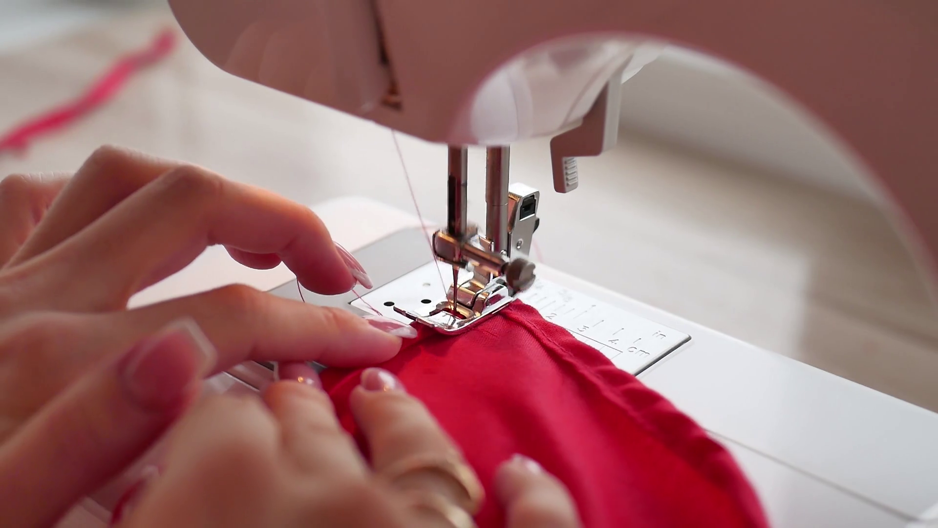 Woman sews on the modern sewing machine. Sewing machine sews close up