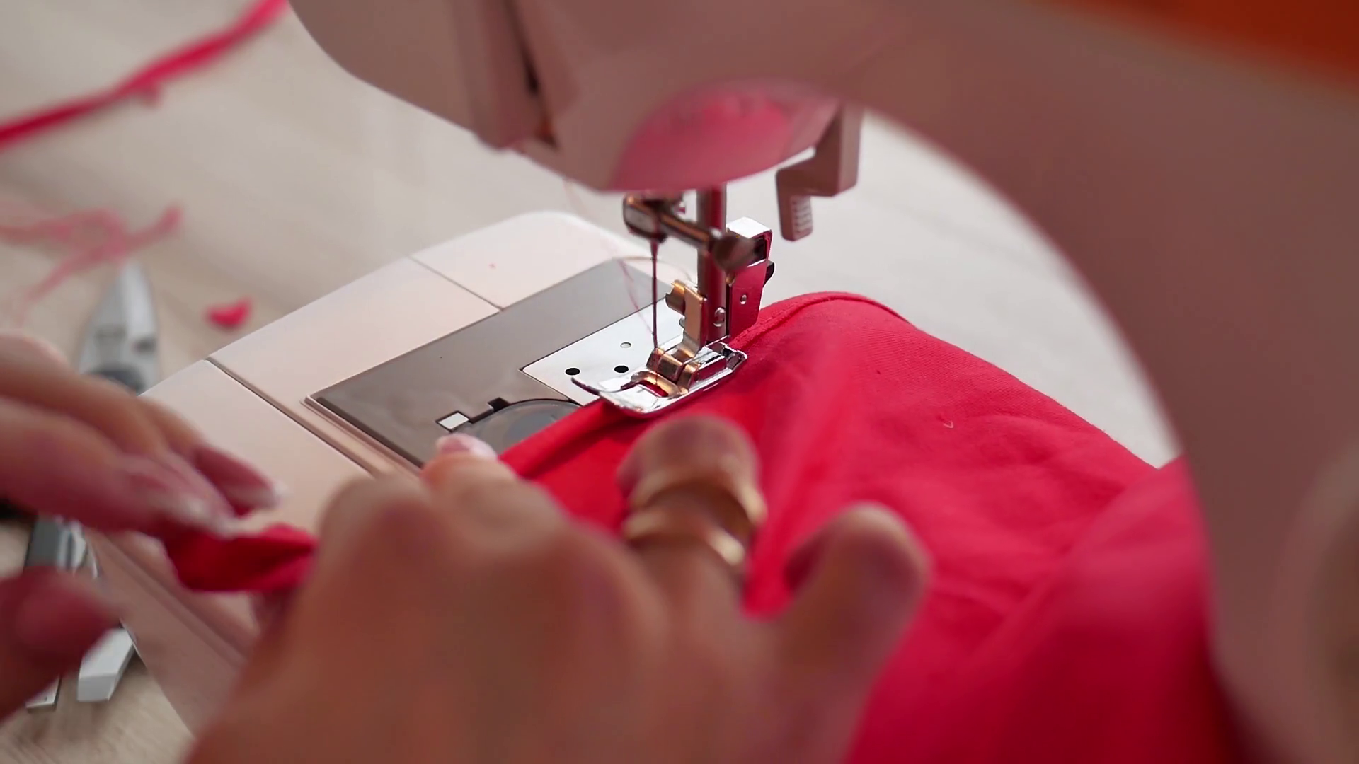 Woman sews on the modern sewing machine. Sewing machine sews close up
