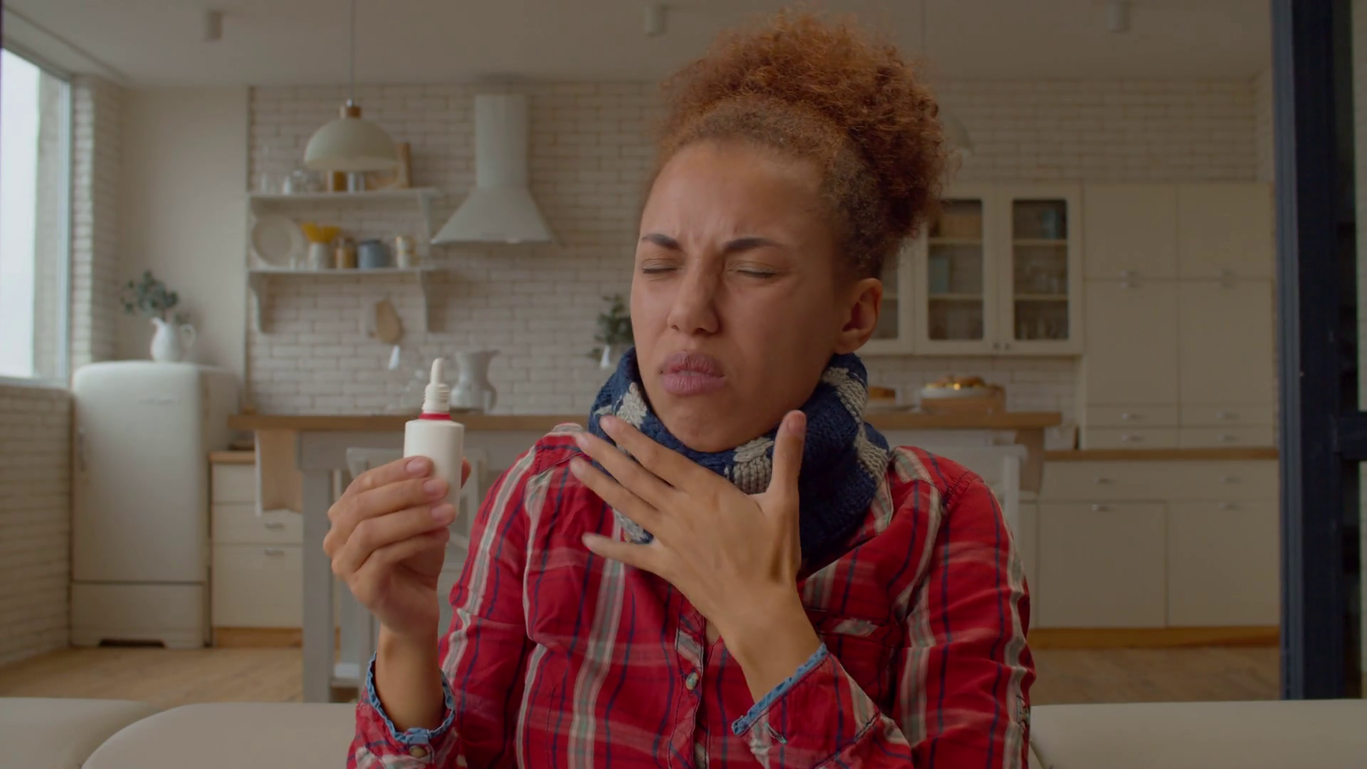 Portrait of ill charming African female with runny nose closing one