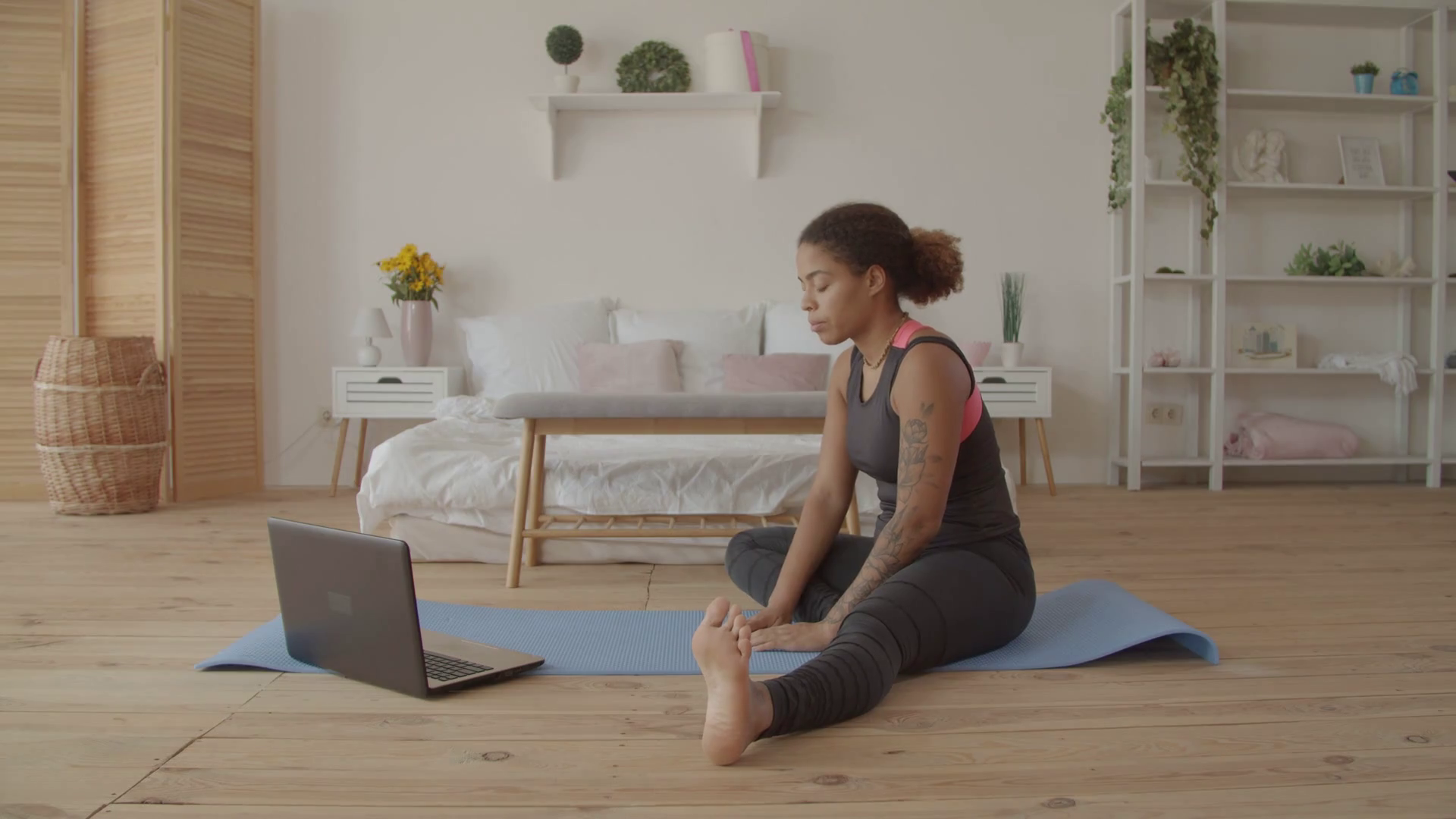 Determined sporty african american woman working out, doing stretching