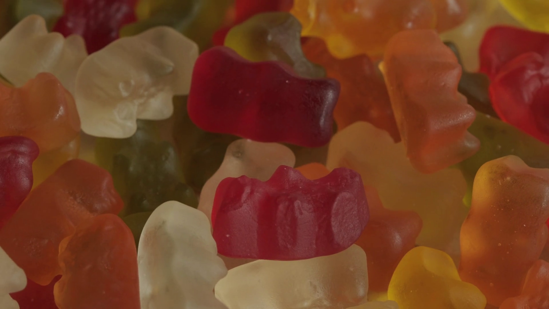 Pile Of Gummy Bear Candy Background Rotating Stock Footage SBV