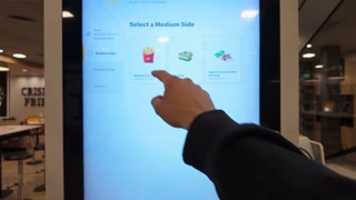Liverpool, England - September 15, 2024: Placing an order through a modern digital ordering kiosk in a McDonald's restaurant to place order for fast-food