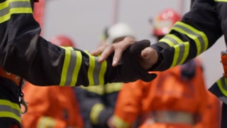 A team of firefighters comes together to celebrate and share their joy and relief after a successful operation, demonstrating the strong