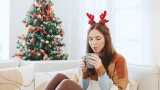 A multinational couple shares warm and joyful moments of the Christmas holidays, relaxing together near a beautifully decorated Christmas