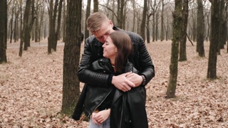 Joyful couple enjoying autumn park together