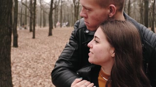 Joyful couple enjoying autumn park together